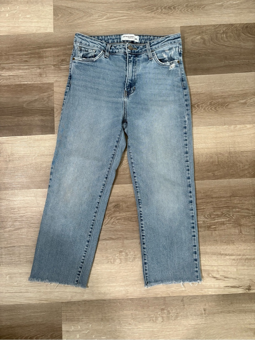 Women’s Light Wash High-Rise Straight Jeans with Raw Hem.